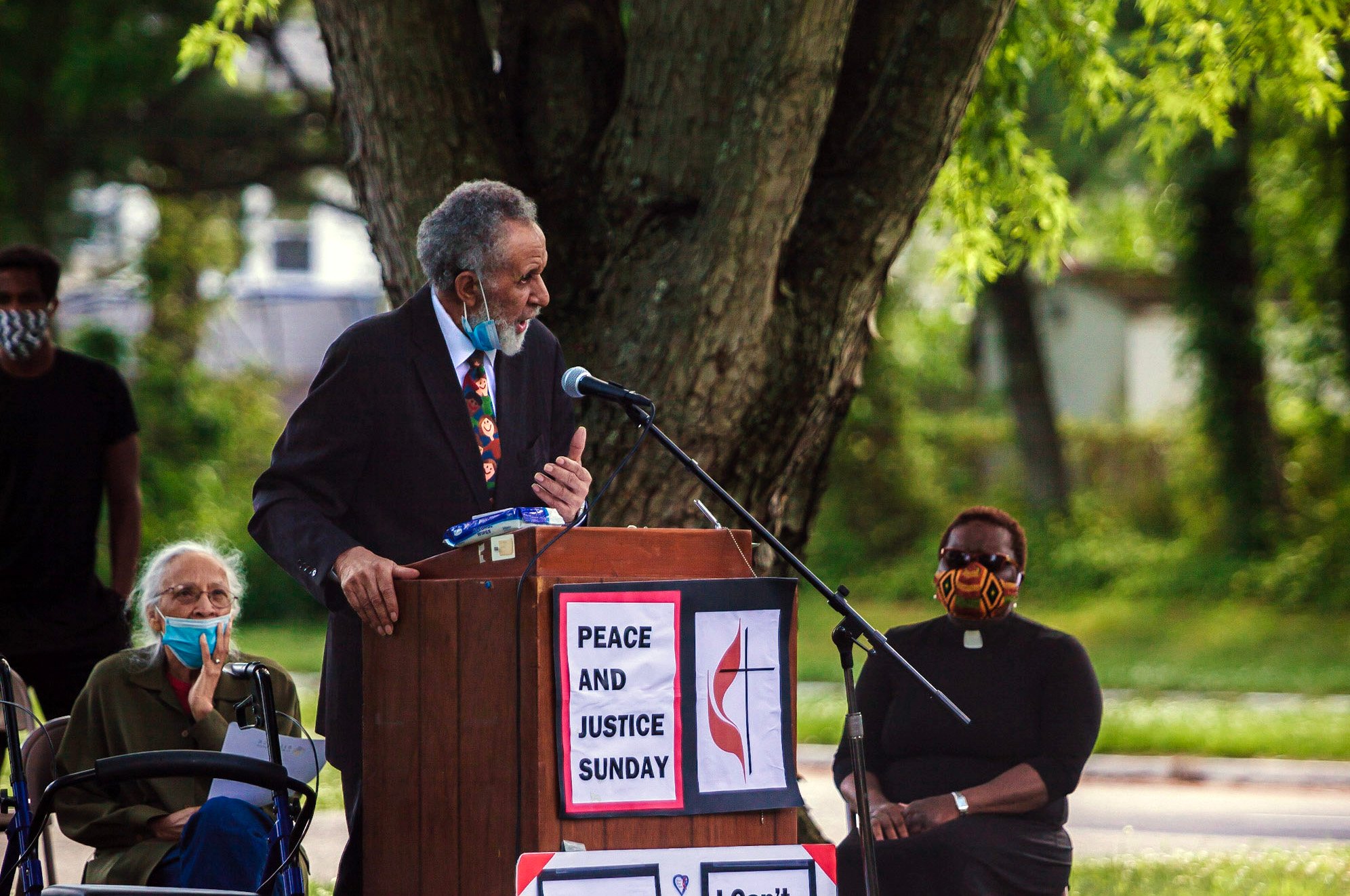 The Rev. Gilbert Caldwell, a retired United Methodist pastor and civil rights activist who marched alongside the Rev. Martin Luther King Jr., speaks during a Black Lives Matter rally June 7 in Willingboro, N.J. To Caldwell's right is his wife, Grace Caldwell. To Caldwell's left is the Rev. Vanessa Wilson, chairperson of the Greater New Jersey Commission on Race and Religion and pastor of Good Shepherd United Methodist Church in Willingboro. The protest was one of many taking place in the U.S. in smaller cities and towns involving United Methodists. Photo by Aaron Wilson Watson