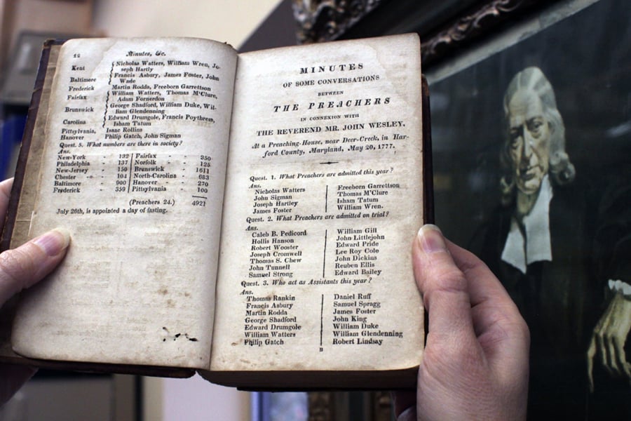 Frances Lyons-Bristol, an archivist-records administrator for the General Commission on Archives and History, holds a book listing early Methodists, including the circuit rider, the Rev. Freeborn Garrettson. Photo by Kathleen Barry, United Methodist Communications.