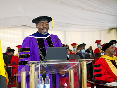 The Rev. Peter Mageto, vice chancellor and professor at Africa University, congratulates graduates on their achievements during the 28th graduation ceremony June 11 in Mutare, Zimbabwe. Mageto highlighted the university’s progress in research, particularly related to malaria, child rights and nursing. Photo courtesy of Africa University.